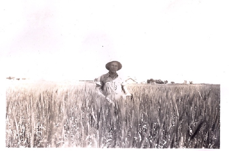 1944-Albert-our farm-behind him.jpg